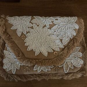 Tan and white floral clutch